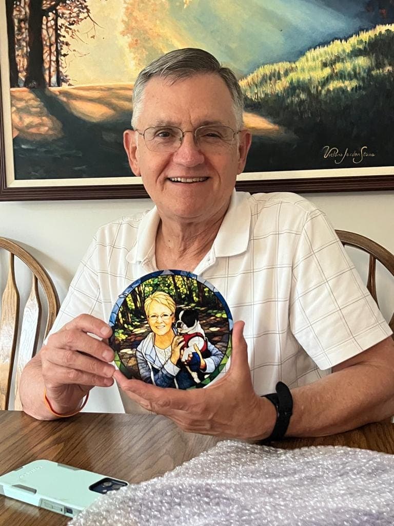 Emily’s father holding the finished stained glass style memorial portrait of her mother