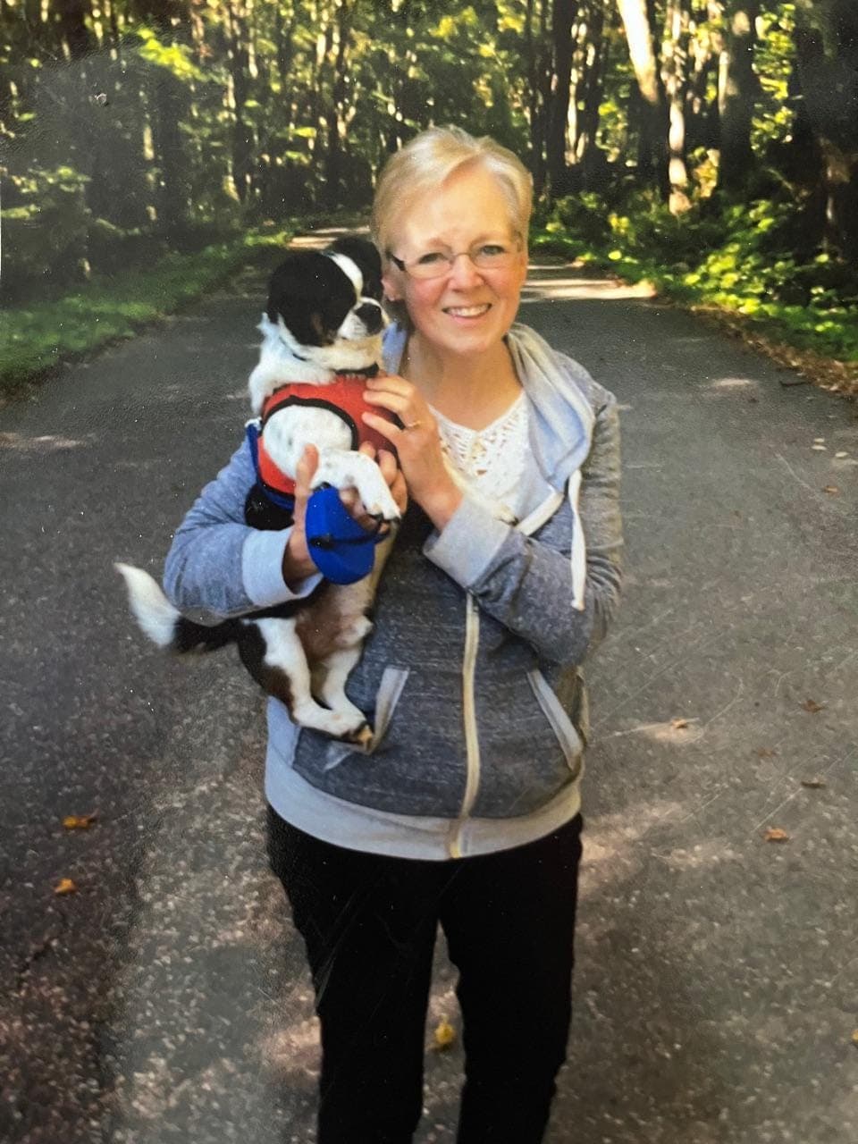 The original family photo Emily sent — her mother holding Buster the dog on a walk